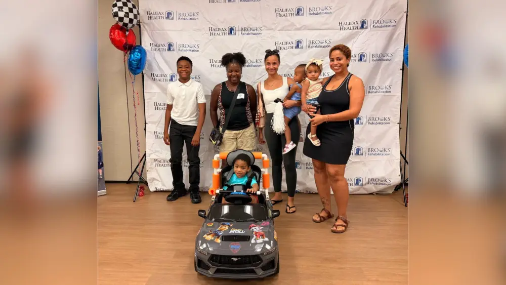 Halifax Health | Brooks Rehabilitation Hosts Go Baby Go Event to Deliver Adaptive Vehicles to Local Children Through Community Partnership