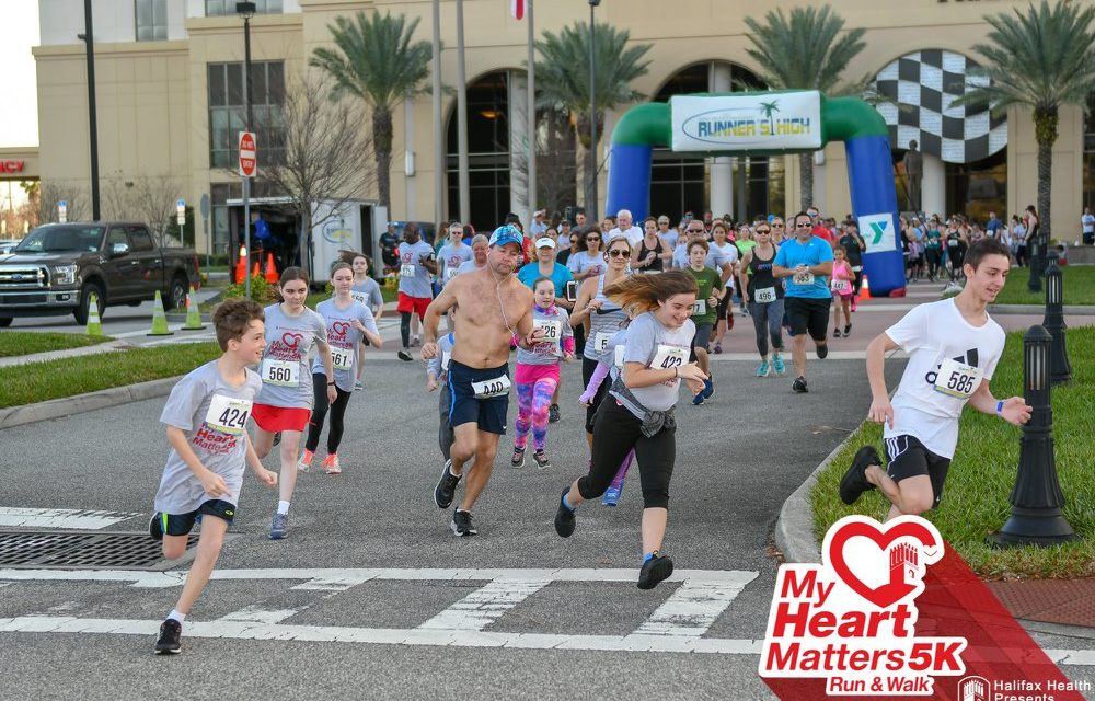 Runners passing the start finish line at the My Heart Matters 5k