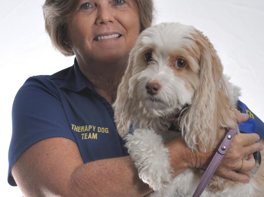 Photo of volunteer Tami Collins and one of Halifax Health therapy dogs