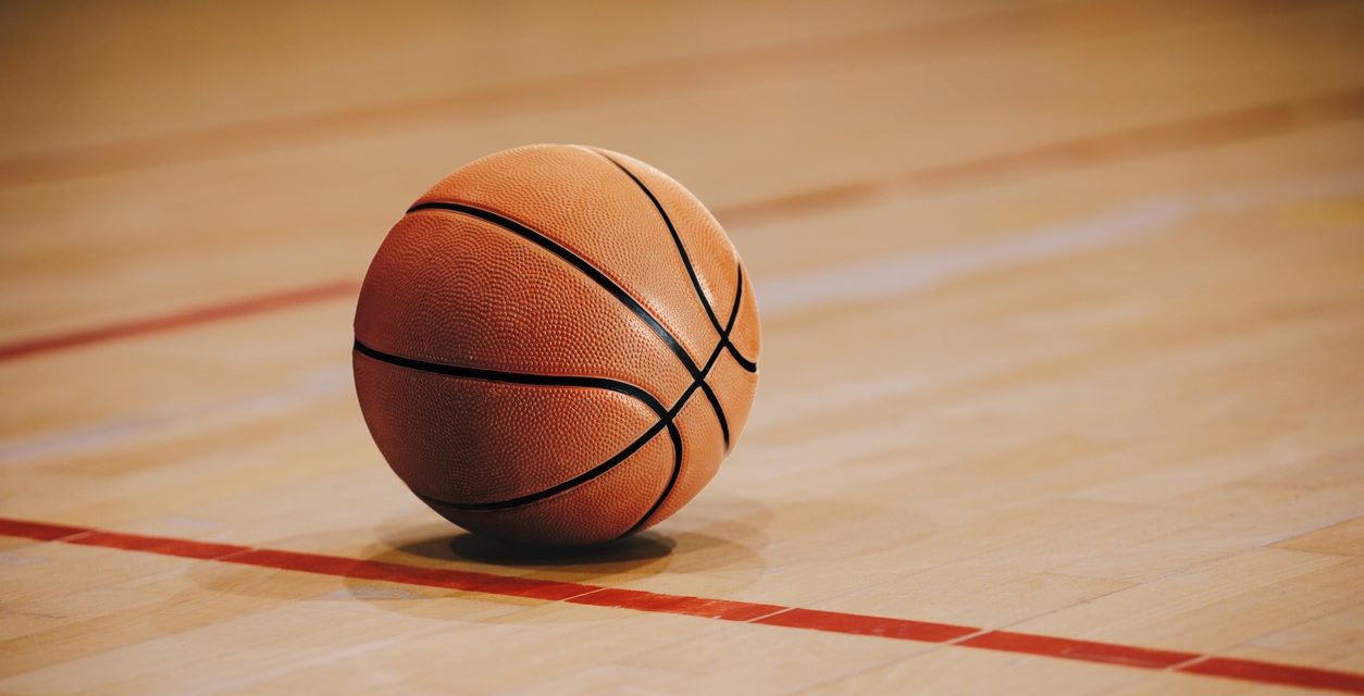 Image of basketball sitting still on basketball floor